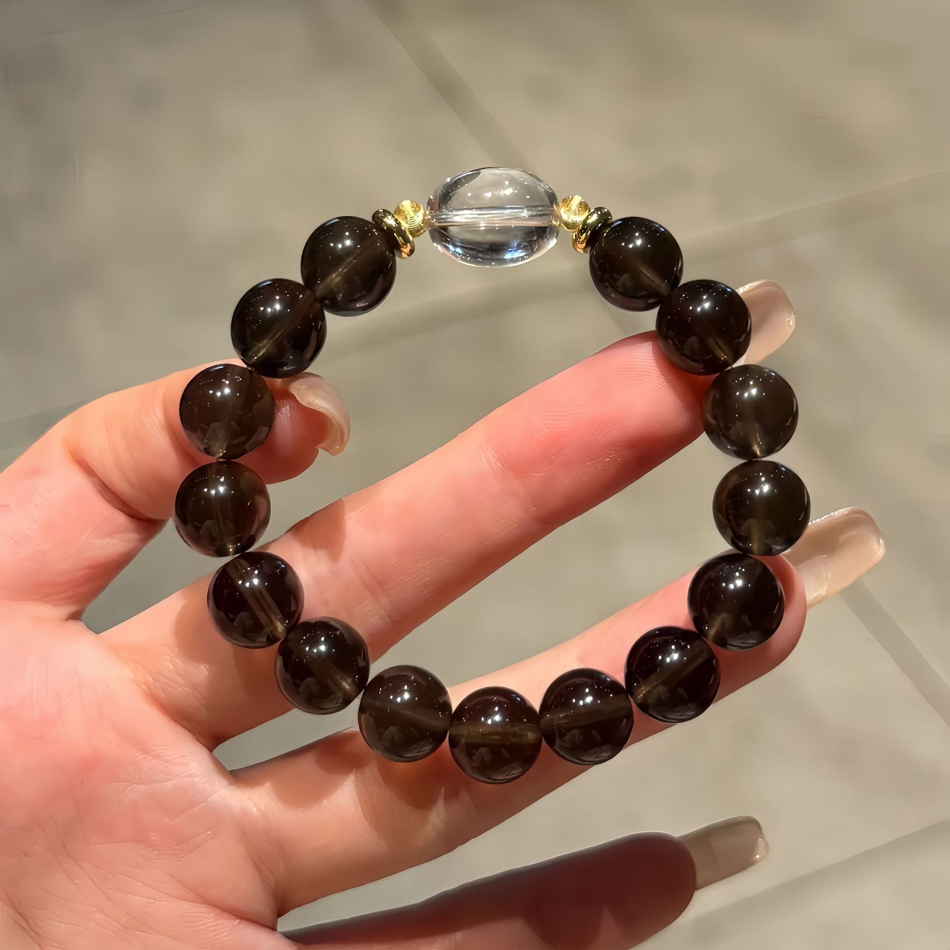 Natural single-strand smoky quartz bracelet accented with clear quartz.