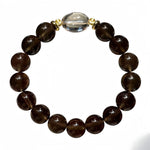 Natural single-strand smoky quartz bracelet accented with clear quartz.