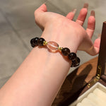 Natural single-strand smoky quartz bracelet accented with clear quartz.